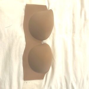 Strapless backless bra with sticky tape on sides and cups. DD.